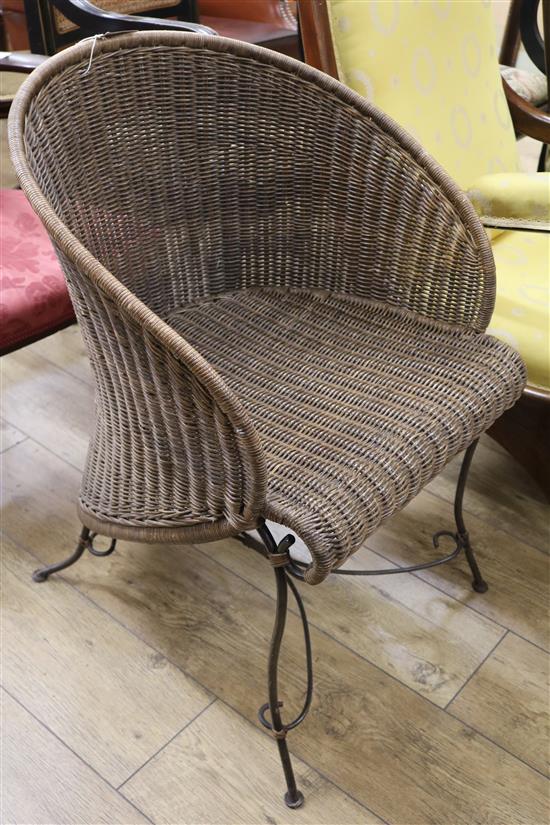 A wicker and iron tub chair